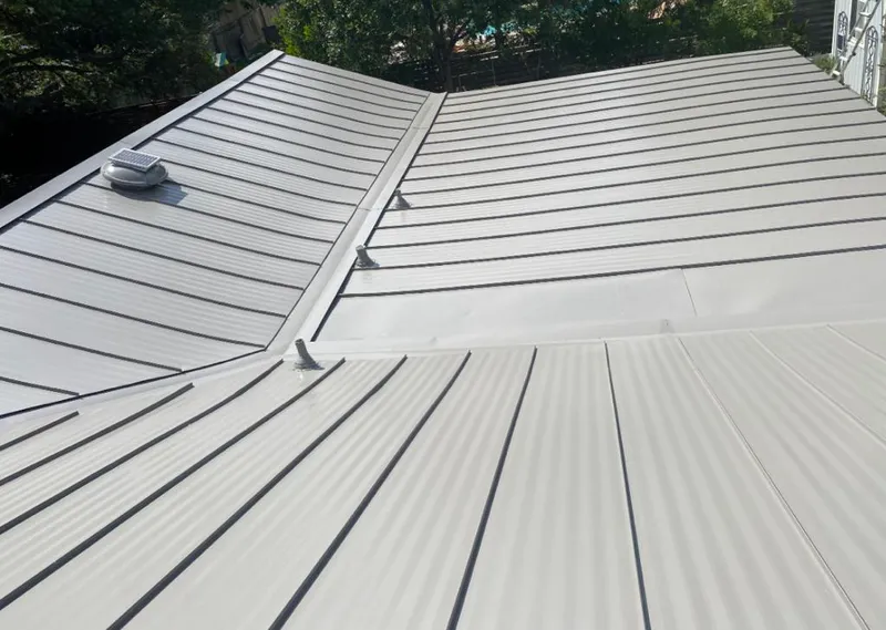 Solar attic fan installed on a metal roof for Roof Ventilation in Hilmar-Irwin